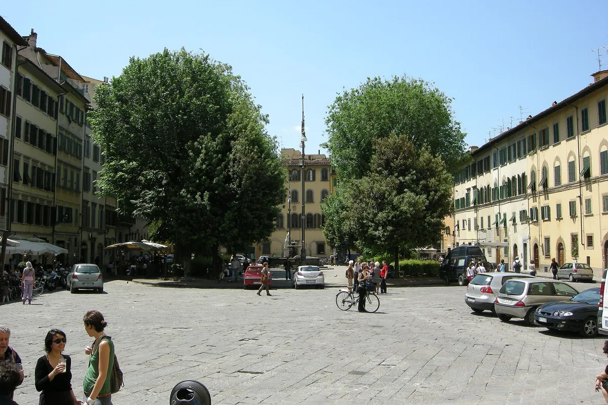 Piazza Santo Spirito in Florence, an open cobbled square with trees and buildings in warm colours on either side
